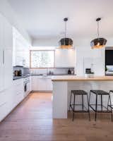 The open-plan, white kitchen helps keep the interiors bright and helps to create a greater sense of spaciousness.