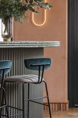 Dining Room, Wall Lighting, Medium Hardwood Floor, Stools, and Bar The paneling on the bar is Mutina Rombini tiles by Ronan and Erwan Bouroullec.  Photo 8 of 8 in A Historic London Property Is Converted Into a Modern Mediterranean Eatery