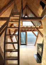 All of the joinery is crafted from plywood offcuts, including the two staircases. Handrails are made from offcuts of blue rope, leftovers from Invisible Studio's Studio in the Woods program. Both gable ends, "glazed" with high-performance interlocking polycarbonate, afford lots of light.