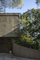 A hovering, monolithic concrete volume forms the bedroom wing and covers the carport. The rear of this volume is the only portion of the home that is visible from the street.&nbsp;