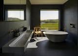 A simple soaking tub makes for a zen-like bath experience.&nbsp;