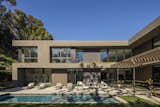 Outdoor, Lap Pools, Tubs, Shower, Back Yard, Large Patio, Porch, Deck, Trees, Grass, and Concrete Patio, Porch, Deck The shaded pool cabana shares the backside of the living room's dual fireplace.  Photos from Live Large in This Marmol Radziner–Designed Home That's Asking $16.9M
