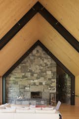 The use of stone carries over into the interiors to create a rustic, elegant, wood-burning fireplace.&nbsp;