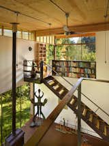 Staircase, Metal Railing, and Wood Tread The double-height interior features a kitchen and living area on the ground level with a sleeping loft above.  Photo 1 of 17 in Office Library from Reclaimed Materials Make Up This Artist Studio in Washington