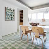 Kitchen, Wall Lighting, Microwave, White Cabinet, and Ceramic Tile Floor The kitchen is large enough for an eat-in  Photos from Color Unites With Texture to Make This Brazilian Abode Appear Much Larger and Brighter