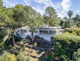 Outdoor, Back Yard, Shrubs, Gardens, Trees, and Large Patio, Porch, Deck In addition to an expansive hillside garden the home also offers off-street parking for five cars.  Photos from Rooney Mara Asks $3.45M For a Restored Midcentury Stunner in L.A.