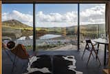 The wall of windows provides a stunning, panoramic view of the local landscape.
