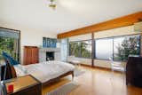 Bedroom, Ceiling, Medium Hardwood, Bed, Dresser, Night Stands, Rug, and Chair The master suite looks out onto the waters of the Bay.  Bedroom Night Stands Bed Dresser Rug Medium Hardwood Photos from This Knockout Midcentury in the Bay Area Will Run You $1.9M