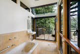 Bath Room, Drop In Tub, Ceramic Tile Floor, Ceramic Tile Wall, Wall Lighting, and Wall Mount Sink T  Photo 13 of 17 in This Knockout Midcentury in the Bay Area Will Run You $1.9M