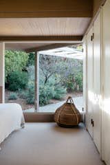 Bedroom, Carpet Floor, Bed, and Wardrobe Even the lower level bedroom features large windows overlooking the property.  Photos from Own a Charismatic L.A. Midcentury Designed by Rudolph Schindler For $1.8M