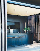 Kitchen, Ceiling Lighting, Laminate Cabinet, Drop In Sink, and Concrete Floor The building is kept low to the ground, so you can step directly from the house into the garden.  Photos from This Australian Abode Is a Glass Pavilion Wrapped in Sliding Hardwood Screens