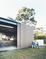 During the winter, the family can slide the screens open to let in the winter sun, in summer they can close the screens to provide shade, while still maintaining views and breezes through the timber battens.