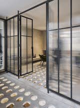 Doors, Metal, Interior, and Swing The glass partition doors assist in opening the space up, while also enhancing the natural light.
  Doors Interior Metal Swing Photos from A London Townhouse Has Glass Circles in Its Floors to Filter in Ample Natural Light