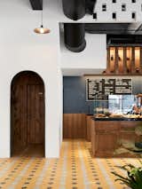 Dining, Cement Tile, Pendant, and Bar Vibrant handmade cement tiles line the floor.  Dining Cement Tile Pendant Photos from This New Brooklyn Cafe Is Brewing Up More Than Tasty Artisanal Coffee