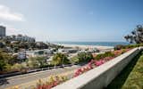 Outdoor, Back Yard, Concrete Fences, Wall, and Grass The property enjoys unobstructed ocean views.  Photos from Case Study House #18 in L.A. Hits the Market at $10M and Includes Plans From Tom Kundig