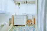 Bright, graphic floor tiles have also been used in the bathroom.&nbsp;