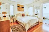 Bedroom, Bed, Medium Hardwood, Night Stands, Dresser, Rug, and Table The home features a classic two-bedroom, two-bathroom floor plan.  Bedroom Table Medium Hardwood Rug Dresser Photos from An Original Venice Craftsman With a Primetime Pedigree Is Listed For $2.75M