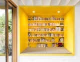 Portland-based In Situ Architecture constructed this 2,700-square-foot, energy-efficient family home. The material palette is designed to age gracefully, featuring stained cedar siding and bright interiors with pops of primary colors throughout.&nbsp;A custom, yellow-painted reading nook is situated near a floor-to-ceiling sliding door that offers direct access to the patio and yard.&nbsp;