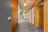 Hallway and Concrete Floor A corridor leads from the entrance to the open-plan living space. Note the original aggregate concrete flooring. 

  Photos from Live Large in This Extra-Spacious Eichler That's Asking $1.38M