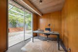 Office, Study, Desk, Laminate, Chair, Rug, and Lamps This is the bonus office space that is complete with original wood paneled walls and a sliding door to the patio. 

  Office Study Laminate Rug Photos from Live Large in This Extra-Spacious Eichler That's Asking $1.38M