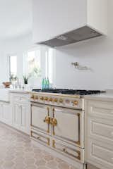 Kitchen, Drop In, Range Hood, White, Range, and Ceramic Tile A beautiful La Cornue range is just one of the many high-end upgrades.  Kitchen Range Drop In Ceramic Tile Photos from An Updated Spanish-Style Abode with an Artist Studio Hits the Market at $1.1M in L.A.