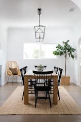 Dining Room, Chair, Pendant Lighting, Medium Hardwood Floor, Table, and Rug Floor The dining room leads to a spacious kitchen.

  Photos from An Updated Spanish-Style Abode with an Artist Studio Hits the Market at $1.1M in L.A.