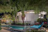 Outdoor, Small, Garden, Small, Horizontal, Trees, and Side Yard A heated pool is on the second lot and is surrounded by lush tropical greenery. 

  Outdoor Side Yard Garden Small Horizontal Photos from A Circular Midcentury Gem in Florida Hits the Market at $1M