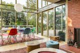 Dining Room, Table, Standard Layout Fireplace, Chair, Pendant Lighting, and Rug Floor Expansive glazing creates a beautiful flow and a strong integration of indoor/outdoor spaces.  Photos from Mad Men Producer Puts His Pasadena Midcentury Up For Auction Starting at $1.7M