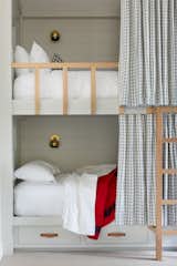 The girls' bedroom was designed for sleepovers and contains four full-size bunk beds and a banquette with a single-size mattress, all custom-designed by ABD Studio. 
