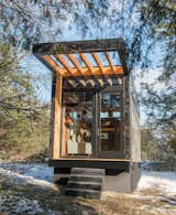 Exterior, Tiny Home Building Type, Glass Siding Material, Metal Siding Material, Wood Siding Material, and Flat RoofLine The tiny home was built on a trailer for easy mobility.  Photo 2 of 12 in This Tiny Home and Writing Studio Was Invented for a Children’s Author