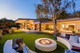 A backyard lounge area complete with a fire pit is perfect for al fresco entertaining.&nbsp;