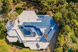 An aerial view of the property clearly shows the home's hexagon-shaped floor plan and central swimming pool courtyard.&nbsp;