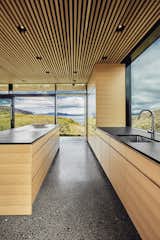 Kitchen, Undermount, Recessed, Wood, Wall Oven, Cooktops, and Concrete The view is framed from every angle.  Kitchen Recessed Concrete Undermount Wall Oven Photos from A Timber-and-Concrete Summer House in Iceland Boasts Breathtaking Views
