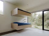 The minimalist, cantilevered bunk beds are a modern interpretation of a traditional bunk room.