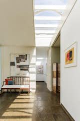 Hallway and Slate Floor Sunlight streams in through skylights and glass walls, allowing the homeowners to feel connected to the setting.  Photos from Own a Sleek Midcentury Abode by Iconic Architect Eliot Noyes For $2.75M