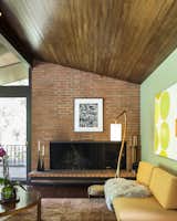A brick, wood-burning fireplace anchors the area.