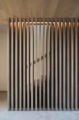 A cedar screen adds an openness to the staircase.