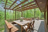 The home is positioned on a gently sloping site and an exterior deck provides views of the surrounding forest. The pergola was built with a removeable awning.&nbsp;
