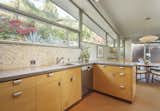 The kitchen opens to the dining area, where clerestory windows provide additional natural light.&nbsp;
