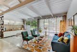 Living Room, Chair, Coffee Tables, Sofa, Rug Floor, and Floor Lighting The soaring tongue-and-groove ceiling adds to the authentic midcentury charm. 

  Photo 4 of 21 in A Carefully Restored Midcentury Hits the Market at $415K in Savannah, Georgia