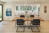 Dining Room, Table, Pendant Lighting, Chair, Light Hardwood Floor, Recessed Lighting, and Stools Silver opened the kitchen to the dining room, creating the sense of one big space with a seamless flow. He also inserted sliding doors to an exterior patio.   Photos from An Iconic Portland Midcentury Is Seeking a New Owner For $1.6M