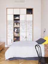Oh My Wall Paris Wallpaper has been placed on wardrobe doors with the shelves painted off-black from Farrow &amp; Ball.&nbsp;