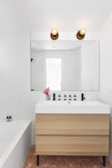 Bath Room, Wall Lighting, Soaking Tub, Drop In Sink, and Ceramic Tile Floor The second bathroom.  Photo 8 of 9 in A Revamped Midcentury Wrapped in Glass and Timber Is Listed For $1.25M