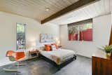 Bedroom, Bed, Chair, Night Stands, Porcelain Tile Floor, Table Lighting, and Dresser All of the bedrooms have a spacious, yet midcentury feel. 

  Photos from A Bright and Breezy Eichler Hits the Market at $1.45M in California