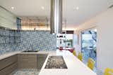 The bright colors and patterns are continued into the sleek design of the kitchen.
