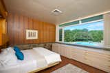 The master bedroom also overlooks the pool and the surrounding natural landscape.