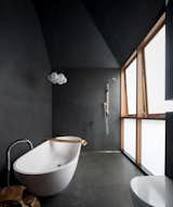 Bath, Freestanding, Open, Pendant, Porcelain Tile, Mosaic Tile, and One Piece The bathroom continues the black perforated theme, and features an asymmetric pitched roof.

  Bath Freestanding Pendant Mosaic Tile Photos from A Dark Sydney Home Finds Light With a Unifying Expansion