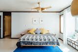 This midcentury bedroom employs a period piece for a ceiling light: the Artemis maple ceiling fan with an incorporated LED light honors the period with organic, undulating forms.