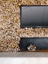 At the back of the pavilion is a double-stacked wood wall and fireplace with a TV.&nbsp;