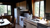Before the renovation, the kitchen was dark, cramped, and in desperate need of updates.

  Photo 5 of 11 in Before & After: A Rundown Cabin Is Reborn as a Chic Residence and Retreat